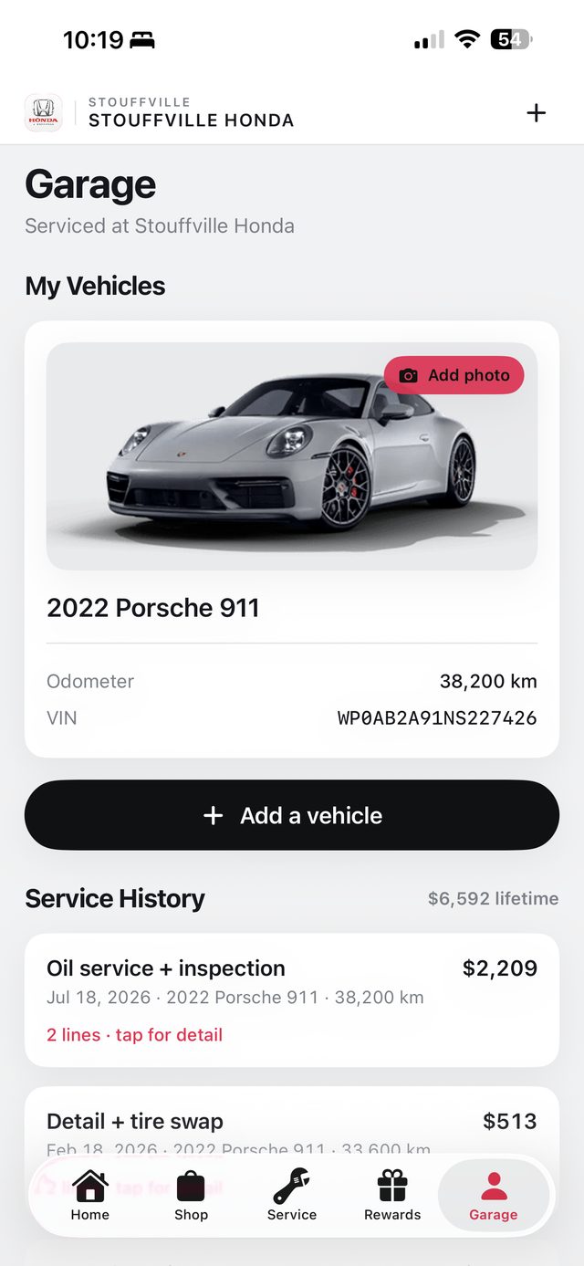 Garage screen: vehicle with photo, VIN, and service history